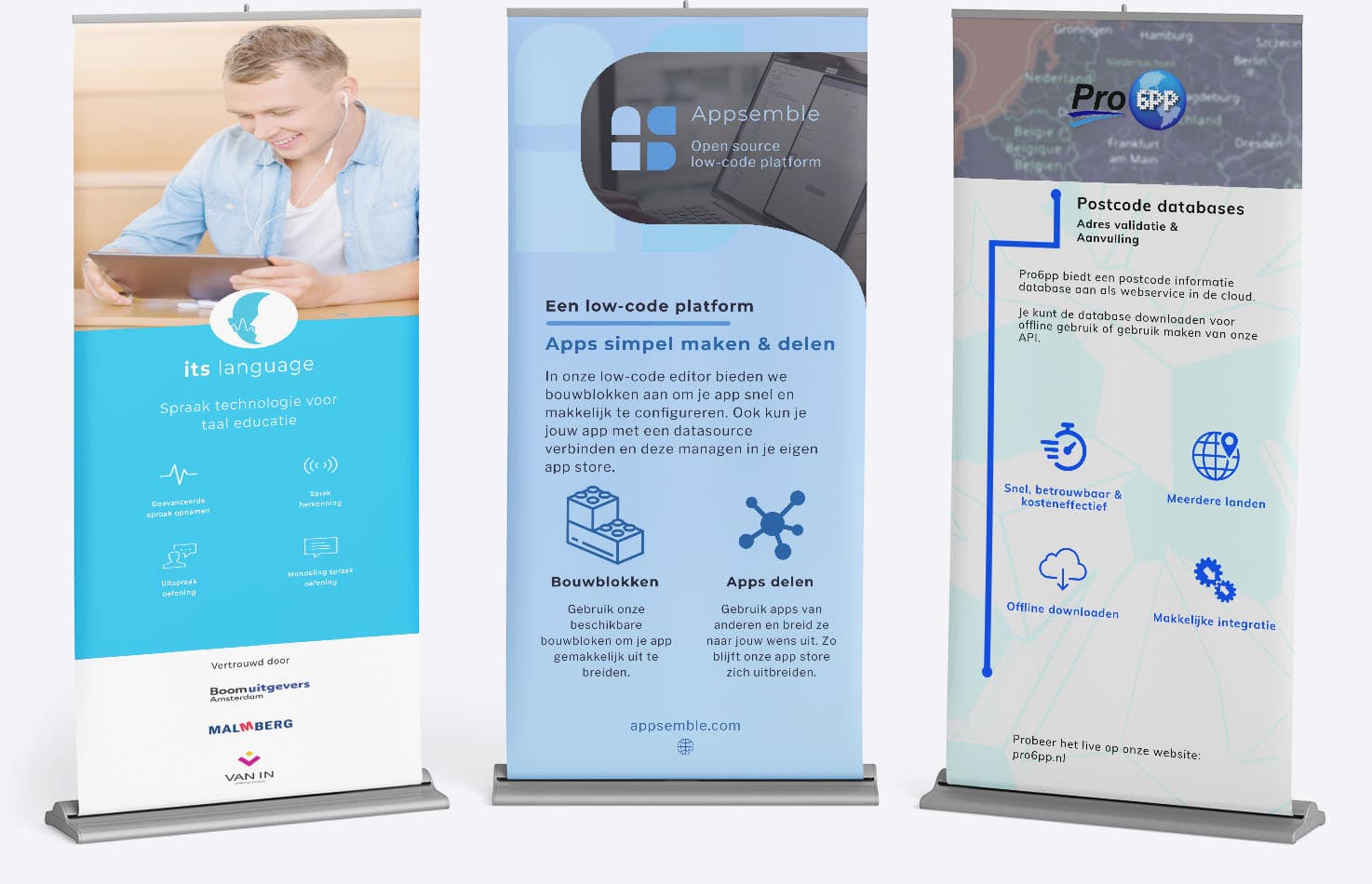 Drie roll-up banners die verschillende technologische producten promoten. Links: 'its language' biedt spraaktechnologie voor taalonderwijs, met functies zoals geavanceerde spraakopname en -herkenning. Midden: 'Appsemble' is een open-source low-code platform voor het eenvoudig bouwen en delen van apps. Rechts: 'Pro 6PP' levert postcode databases voor adresvalidatie en automatische aanvulling, beschikbaar in meerdere landen.